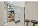 Well-organized laundry area includes shelving, storage, and stacked washer and dryer at 1099 Nokomis S Ave, Venice, FL 34285