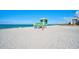 Brightly colored lifeguard stand on a sunny beach with clear blue waters, ensuring safety for swimmers at 1099 Nokomis S Ave, Venice, FL 34285
