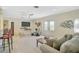 Comfortable living area featuring bright natural light, relaxed seating, and media for entertainment at 1099 Nokomis S Ave, Venice, FL 34285
