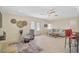 Bright living room boasts a ceiling fan, neutral tones, a cozy chair, and easy access to the outdoor patio at 1099 Nokomis S Ave, Venice, FL 34285