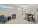Bright living area featuring light hardwood floors and casual seating arrangement with a table and chairs at 1099 Nokomis S Ave, Venice, FL 34285