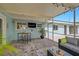 Covered patio with comfortable seating, perfect for outdoor entertaining at 1099 Nokomis S Ave, Venice, FL 34285