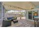 Inviting screened-in patio with cozy seating and a view of the pool at 1099 Nokomis S Ave, Venice, FL 34285