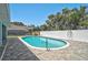Inviting pool and paver patio with a white fence adding privacy to the outdoor space at 1099 Nokomis S Ave, Venice, FL 34285