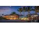 Beachfront restaurant with outdoor seating and palm trees under a twilight sky with a full moon at 1099 Nokomis S Ave, Venice, FL 34285