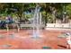 Splashpad area in a park with water fountains, benches, and surrounding greenery at 1099 Nokomis S Ave, Venice, FL 34285