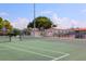 Well-kept tennis courts with green surfaces and clear skies, great for tennis enthusiasts and active lifestyles at 1099 Nokomis S Ave, Venice, FL 34285