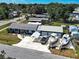 An aerial view of a home with a long driveway, a garage, and two boats parked in the drive at 1103 Lucille Ave, Nokomis, FL 34275