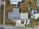 An aerial top view shows the home and garage with boats parked in the driveway at 1103 Lucille Ave, Nokomis, FL 34275