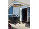 View of covered backyard area with grill and additional exterior storage at 1103 Lucille Ave, Nokomis, FL 34275