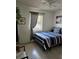 Neutral bedroom with natural light, ceiling fan, and striped bedding at 1103 Lucille Ave, Nokomis, FL 34275
