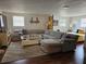 Cozy living room featuring a large sectional sofa and seamless flow into bedroom area at 1103 Lucille Ave, Nokomis, FL 34275