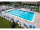 Expansive pool area with numerous lounge chairs and umbrellas, perfect for relaxation at 1154 Bird Bay Way # 303, Venice, FL 34285