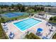 Aerial view showcasing the pool, tennis courts, and meticulously maintained landscaping at 1154 Bird Bay Way # 303, Venice, FL 34285