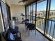 Enclosed balcony with outdoor seating and exercise bike overlooks serene lake and fountain at 1154 Bird Bay Way # 303, Venice, FL 34285