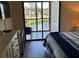 Balcony access from the bedroom, offering views of a fountain and waterfront at 1154 Bird Bay Way # 303, Venice, FL 34285