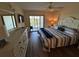 Bright bedroom with waterfront views from the balcony, ceiling fan, and large white dresser at 1154 Bird Bay Way # 303, Venice, FL 34285