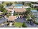 Community aerial view featuring the community center, pools, parking, tennis courts, and well-manicured lawns at 1154 Bird Bay Way # 303, Venice, FL 34285