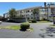 Well-maintained condominium complex showcases lush landscaping and covered parking areas at 1154 Bird Bay Way # 303, Venice, FL 34285
