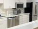 Convenient kitchenette featuring stainless steel appliances and ample countertop space at 1154 Bird Bay Way # 303, Venice, FL 34285