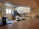 Kitchen featuring white cabinetry, stainless steel appliances, and a breakfast bar with counter seating at 1154 Bird Bay Way # 303, Venice, FL 34285