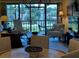 Open floor plan showcases a dining area and a living room with access to the lanai and lake views at 1154 Bird Bay Way # 303, Venice, FL 34285