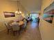 Open floor plan showcases a dining area with a chandelier and a living room with access to the lanai at 1154 Bird Bay Way # 303, Venice, FL 34285