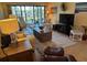 Living room showcasing open floor plan with access to the lanai and serene lake views at 1154 Bird Bay Way # 303, Venice, FL 34285