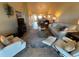 Inviting living room featuring comfortable seating, a decorative rug, and an open layout to the dining area at 1154 Bird Bay Way # 303, Venice, FL 34285