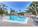 Community pool featuring clear blue water, lounge chairs, and well-maintained deck for residents at 1154 Bird Bay Way # 303, Venice, FL 34285