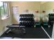 Dedicated weight room featuring a variety of dumbbells, fitness balls, and workout bench at 1154 Bird Bay Way # 303, Venice, FL 34285