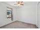 Cozy bedroom featuring neutral carpet, a fan, and a window at 12014 Creek Preserve Dr, Riverview, FL 33579