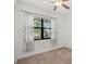 This bedroom with neutral carpet features a window with sheer curtains at 12014 Creek Preserve Dr, Riverview, FL 33579