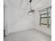 Bright dining room with modern light fixture, white walls and tile flooring at 12014 Creek Preserve Dr, Riverview, FL 33579