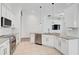 Modern kitchen featuring white cabinets, stainless steel appliances, and a granite countertop island at 12014 Creek Preserve Dr, Riverview, FL 33579
