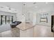 Open-concept living room with a large sectional sofa, tile floors, and sliding glass doors to the pool area at 12014 Creek Preserve Dr, Riverview, FL 33579