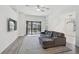 Open living room features a gray couch and large sliding doors to the outdoor pool area at 12014 Creek Preserve Dr, Riverview, FL 33579