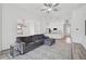 Open-concept living room with a gray sectional sofa and views of the kitchen and dining area at 12014 Creek Preserve Dr, Riverview, FL 33579