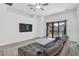 Spacious living room featuring a comfortable sofa, large TV, and sliding glass doors to the outdoor space at 12014 Creek Preserve Dr, Riverview, FL 33579