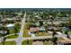 An aerial view of a neighborhood showcasing single-Gathering homes and tree-lined streets at 1203 Hudson Rd, Venice, FL 34293