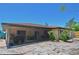 Backyard of home features a screened in porch, desert landscaping, and a chain link fence at 1203 Hudson Rd, Venice, FL 34293