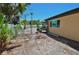 Backyard view of home features a desert landscape and a chain link fence next to a white fence at 1203 Hudson Rd, Venice, FL 34293