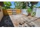 Backyard of home with a partial desert landscape and a wooden fence in the background at 1203 Hudson Rd, Venice, FL 34293