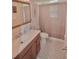 Bright bathroom featuring a single sink vanity, a mirrored cabinet, and a shower with a curtain at 1203 Hudson Rd, Venice, FL 34293