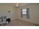 Simple bedroom with carpet, a window, and minimal decor at 1203 Hudson Rd, Venice, FL 34293