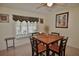 Cozy dining area with a table and four chairs, complemented by a window with mini blinds at 1203 Hudson Rd, Venice, FL 34293