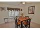 Cozy dining room with neutral walls, a ceiling fan, and a window providing natural light at 1203 Hudson Rd, Venice, FL 34293