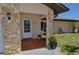 Close-up of the home's entrance, highlighting stone columns and a tiled porch at 1203 Hudson Rd, Venice, FL 34293