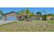 Charming single-Gathering home with a two-car garage, stone details, and mature landscaping at 1203 Hudson Rd, Venice, FL 34293