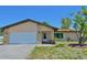 Charming single-Gathering home with a two-car garage, stone details, and fresh landscaping at 1203 Hudson Rd, Venice, FL 34293
